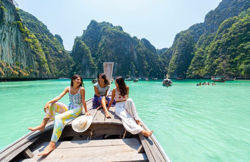 friends on a boat in thailand