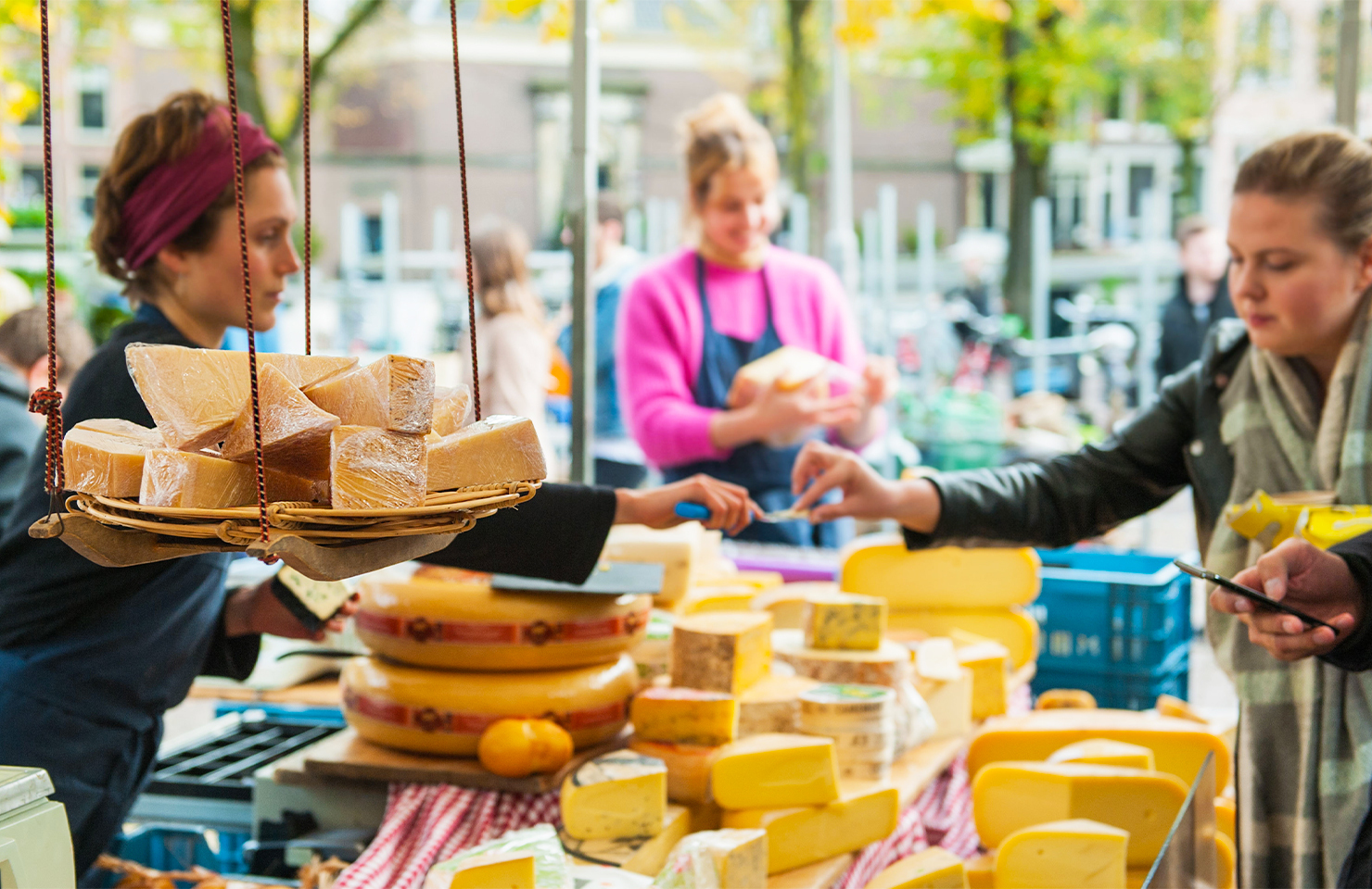 people selling cheese at a market in amsterdam