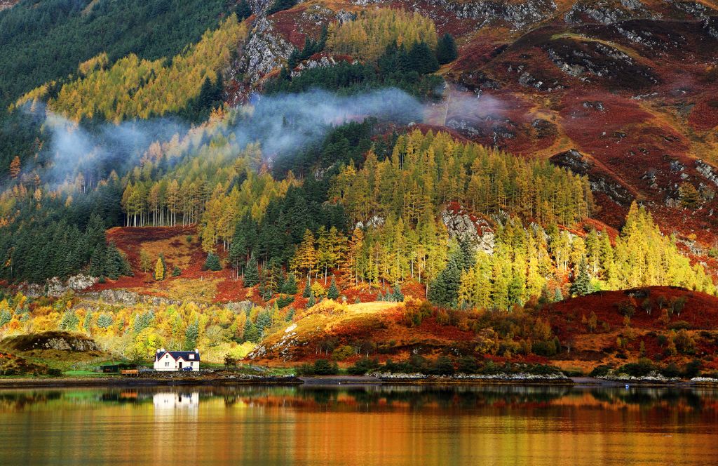 autumn in scotland - a house in the highlands on a loch