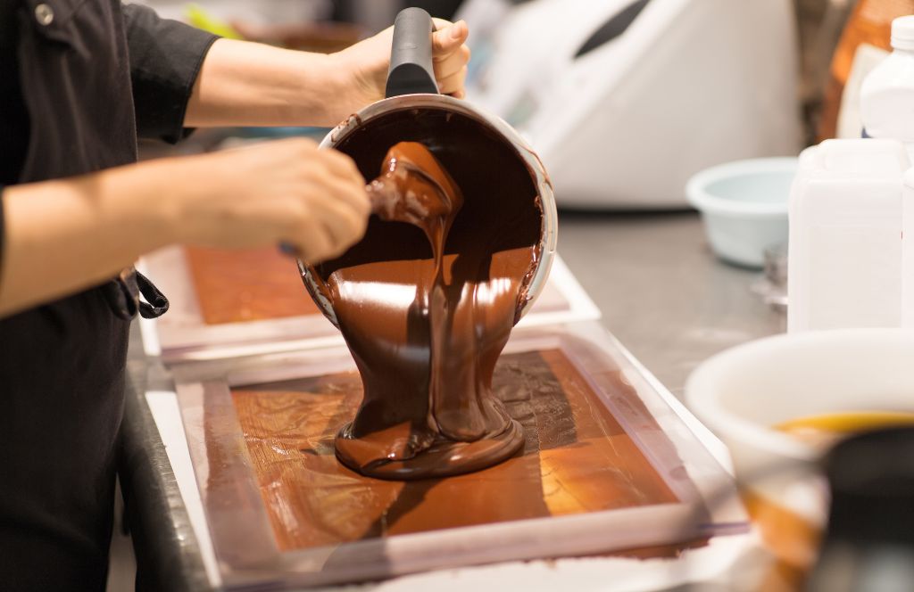 someone enjoys a chocolate making experience in london thanks to our activity gift vouchers