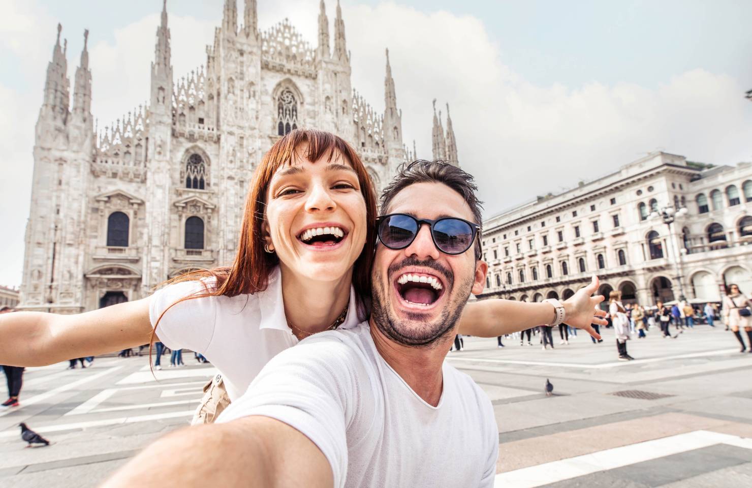 Couple taking a selfie in front of the Milan Duomo