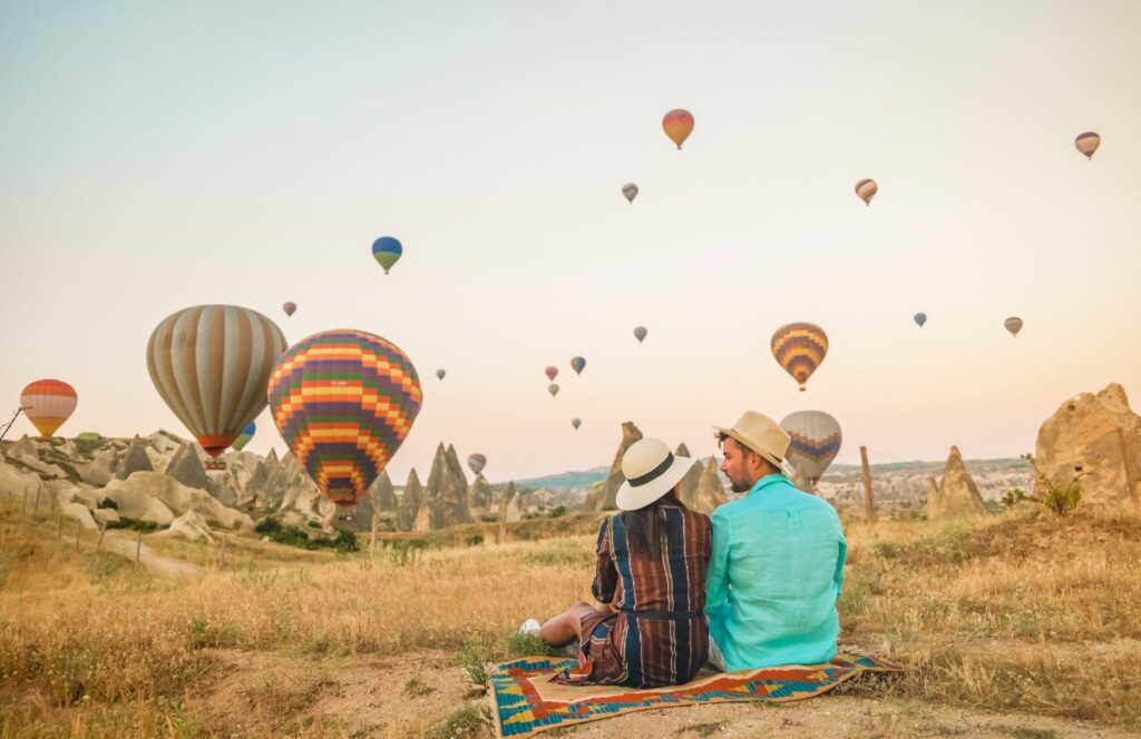 couple watching hot air balloons