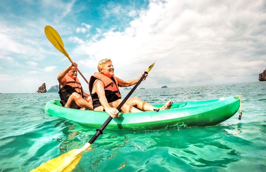 a couple kayak laughing doing one of the best gift experiences for couples