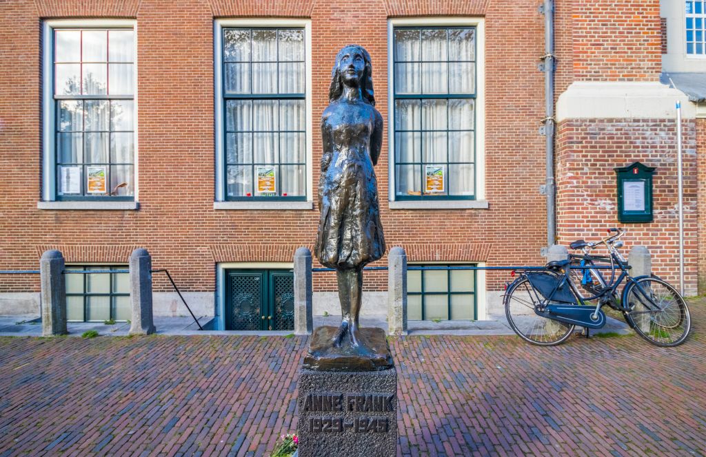 statue of anne frank outside of the anne frank museum in amsterdam