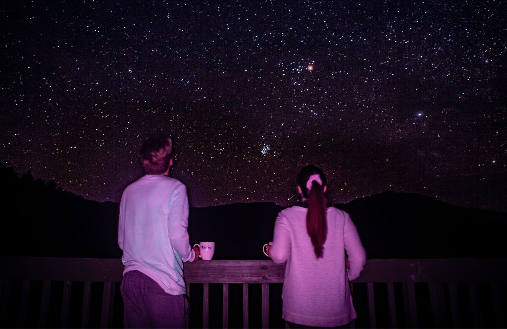 a couple take part in a stargazing experience 