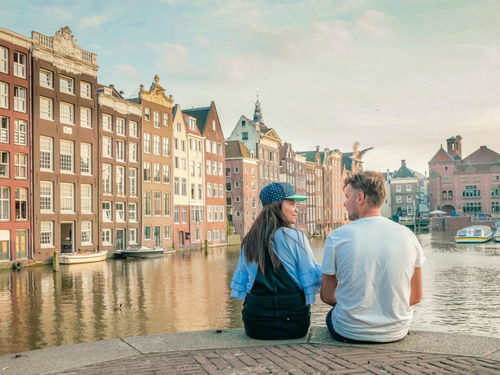 things to do in amsterdam for couples include sitting on the banks of the canals