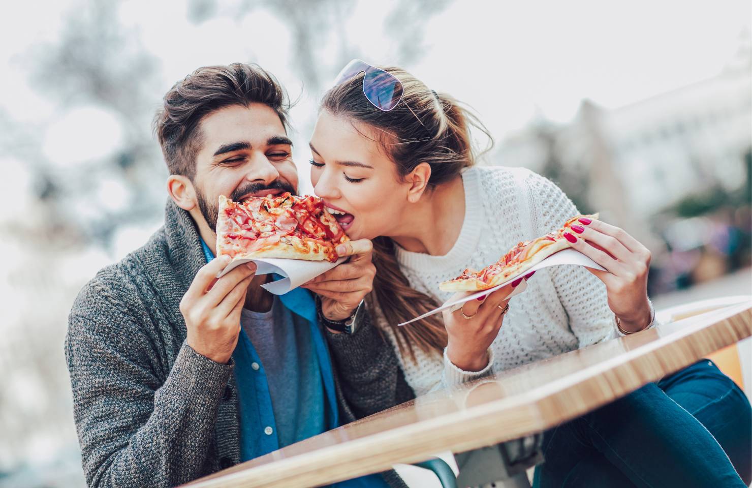 A couple share pizza in Italy