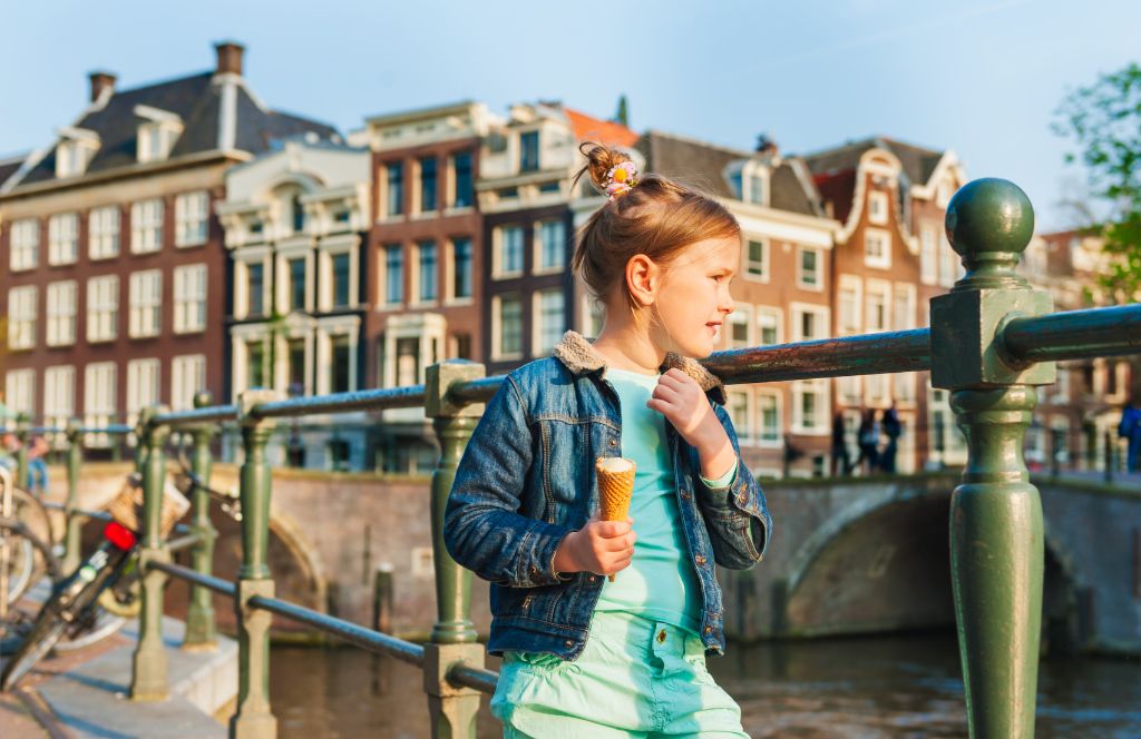 a child enjoys an ice cream while on a family holiday in amsterdam