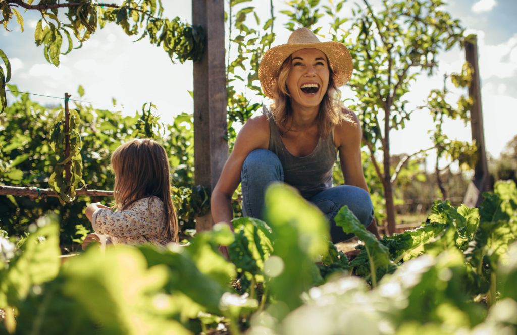 a woman with your daughter in a vegetable patch