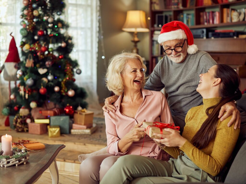 a family take part in a funny christmas gift exchange idea and laugh