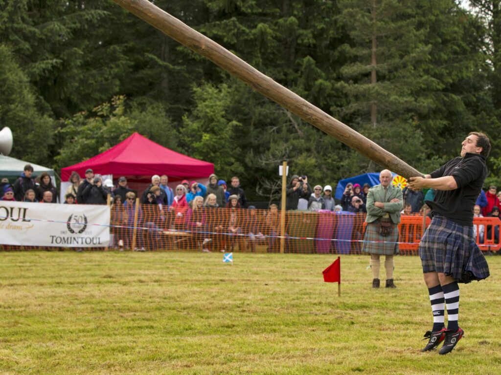 a man tossing the caber on a highland games tour redeemable with our activity gift vouchers