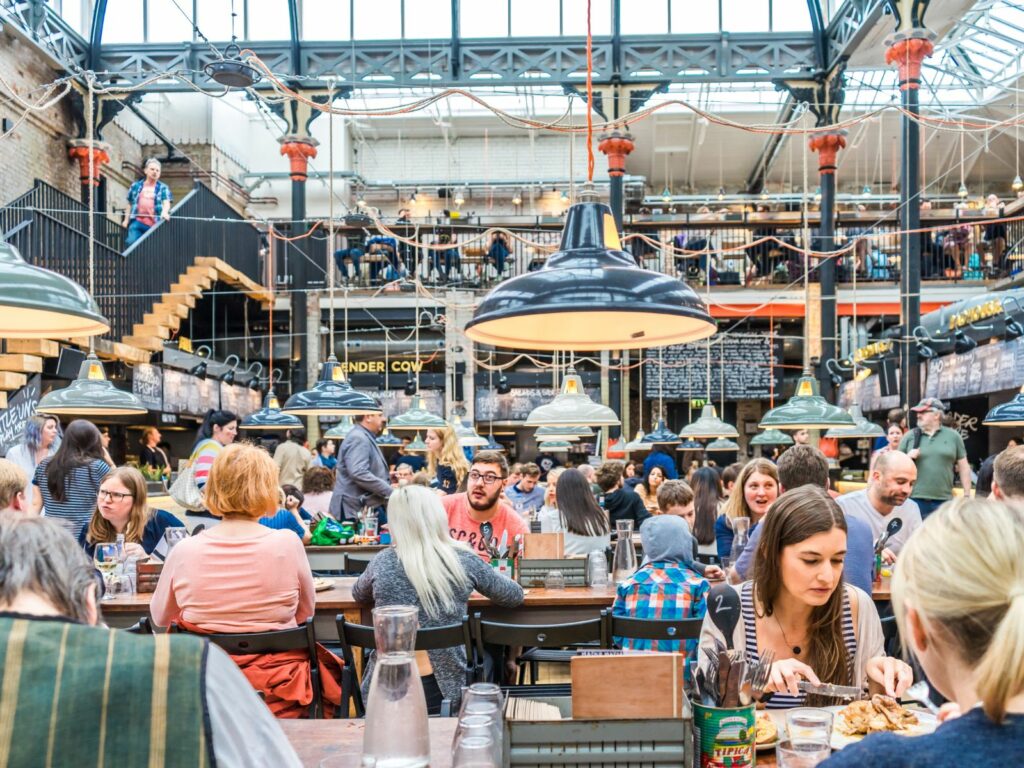people enjoying one of the best manchester experiences in a food hall