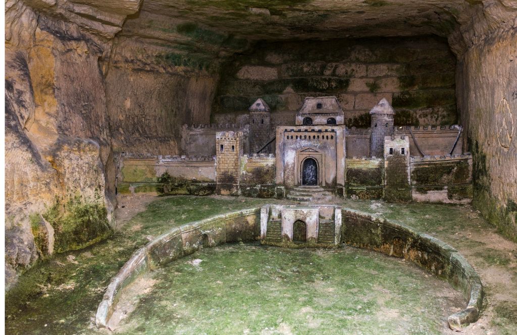 a sculpture of a castle in the paris catacombs - one of the best paris activities