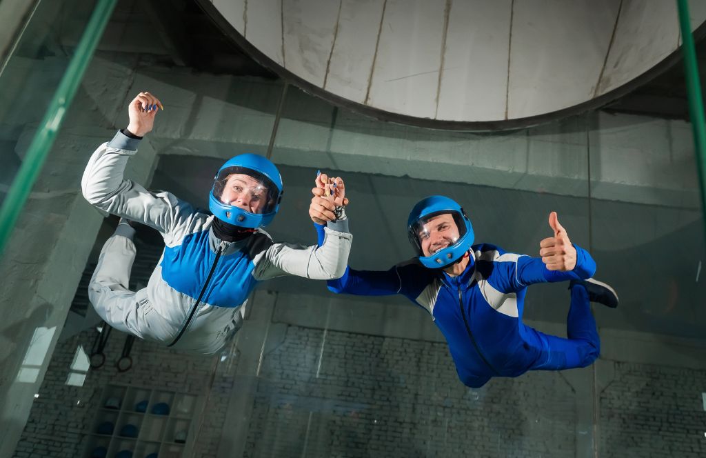 a man and woman do indoor skydiving as one of the best experience gifts for sisters