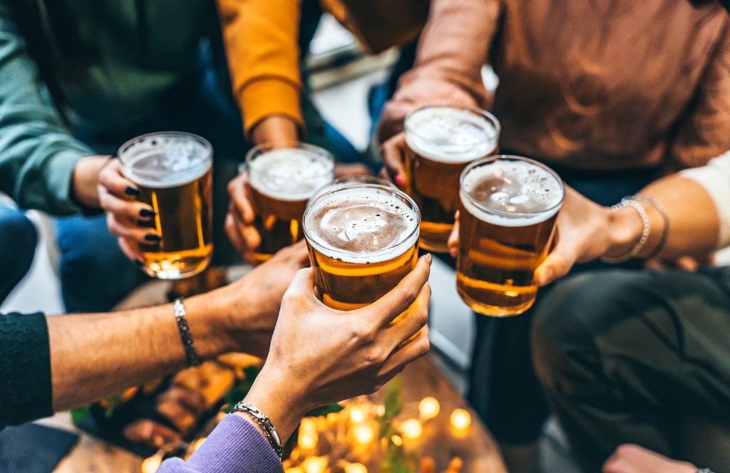 friends toast pints in a london pub