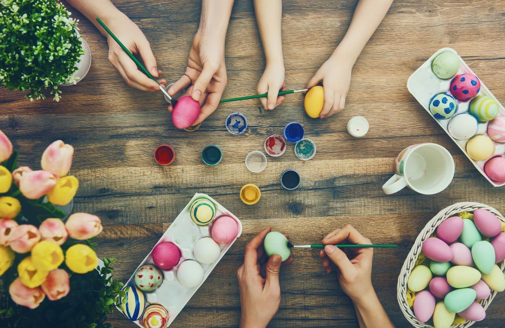 kids decorate eggs as a fun easter activity